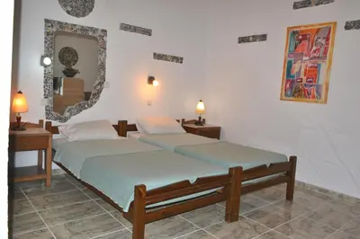 two beds in a room with a mirror at Beach Studio next to the center in Kissamos