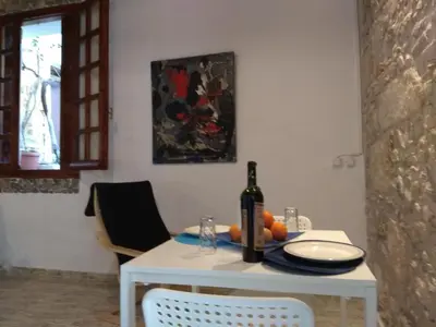 a white table with a bottle of wine and fruit on it at Beach Studio next to the center in Kissamos