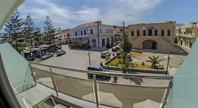 a view of a city street from a balcony at Beach Studio next to the center in Kissamos