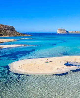 a person standing on a beach in the ocean at Beach Studio next to the center in Kissamos