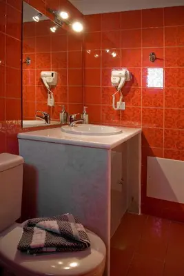 a bathroom with a sink and a toilet at Syia Hotel in Sougia