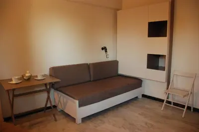 a couch in a room with a table and a chair at Seafalios in Kalamaki Chanion