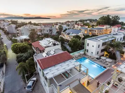 an aerial view of a house with a swimming pool at Athina Beach Hotel in Kato Daratso