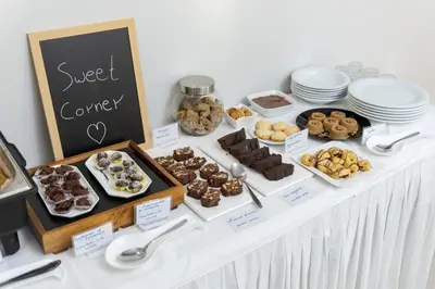 a buffet of pastries and desserts on a table at Athina Beach Hotel in Kato Daratso