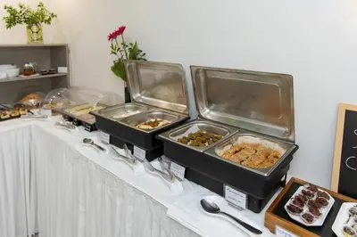 a buffet with trays of food on a table at Athina Beach Hotel in Kato Daratso