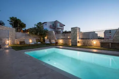 a swimming pool in front of a building at Pantanassa Villa Thalia in Agia Marina Nea Kydonias