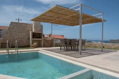 a pavilion over a swimming pool in a house at Pantanassa Villa Thalia in Agia Marina Nea Kydonias
