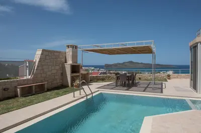 a swimming pool in a house with a view of the ocean at Pantanassa Villa Thalia in Agia Marina Nea Kydonias