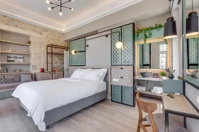 a bedroom with a bed and a desk at 1924 suites in Chania Town