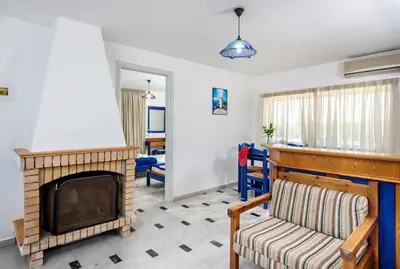 a living room with a fireplace and a couch at Matzi Hotel Apartments in Gerani Chanion