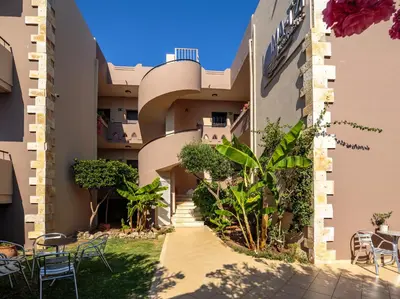 a view of the side of a building with tables and chairs at Matzi Hotel Apartments in Gerani Chanion