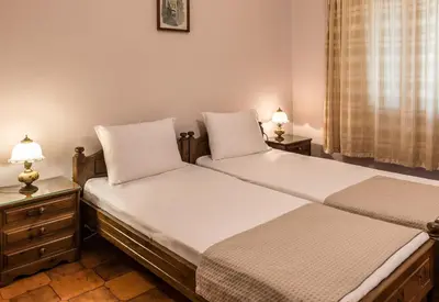 two beds sitting next to each other in a bedroom at Villa Merabello in Agia Marina Nea Kydonias