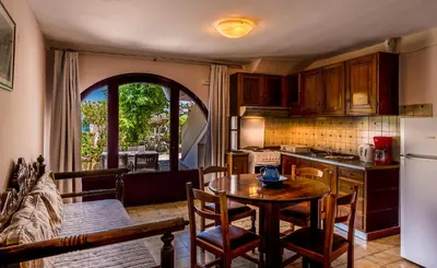 a kitchen with a table and a refrigerator and a table at Villa Merabello in Agia Marina Nea Kydonias