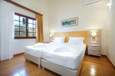 a large white bed in a room with a window at Villa Thealassa - Hanging Over the Sea by etouri in Kounoupidhianá