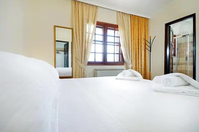 a bedroom with a white bed with towels on it at Villa Thealassa - Hanging Over the Sea by etouri in Kounoupidhianá