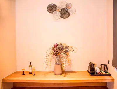 a table with a vase of flowers on a wall at Portou House in Chania Town