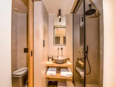 a bathroom with a sink and a shower at Portou House in Chania Town