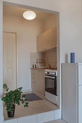 a kitchen with a stove and a refrigerator at Sody Magnificent Bay View in Chania Town