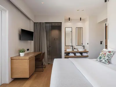 a hotel room with a bed and a bathroom at Theofilos City Hotel in Chania Town