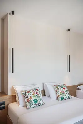 a white bed with pillows on top of it at Theofilos City Hotel in Chania Town