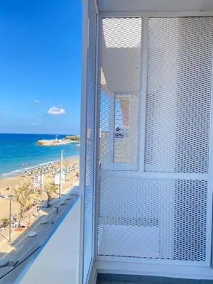 a balcony with a view of the beach at Frini Hotel in Chania Town