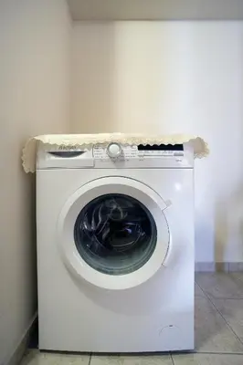 a white washing machine sitting in a room at Dimitra's House in Old Town in Chania Town