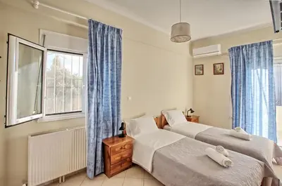 a bedroom with two beds and a window at Gianna's House in Gerani Chanion