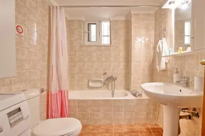 a bathroom with a tub and a toilet and a sink at Gianna's House in Gerani Chanion