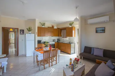 a kitchen and living room with a couch and a table at Gianna's House in Gerani Chanion