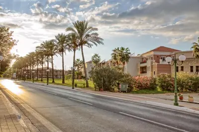 an empty street with palm trees and houses at Gianna's House in Gerani Chanion