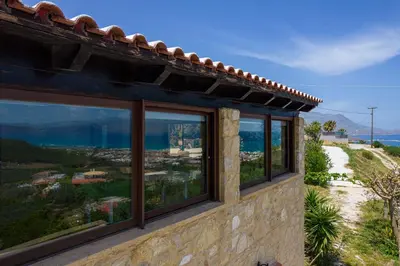 a house with windows on the side of it at Villa dimitris in Kissamos
