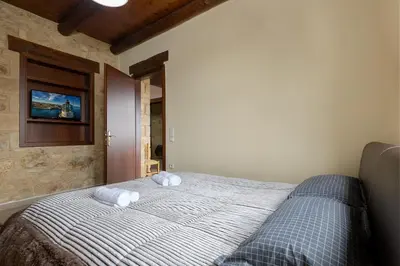 a bedroom with a bed with two towels on it at Villa dimitris in Kissamos