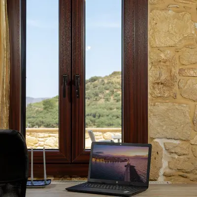 a laptop computer sitting on a table in front of a window at Villa dimitris in Kissamos