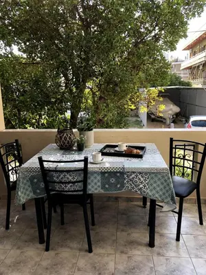 a table with two chairs and a tablecloth on a patio at Rosy's House with all Amenities near Chania in Chania Town