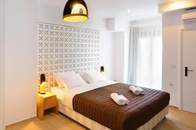 a bedroom with a bed with two towels on it at Elia Beach in Chania Town