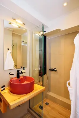 a bathroom with a red sink and a shower at Elia Beach in Chania Town