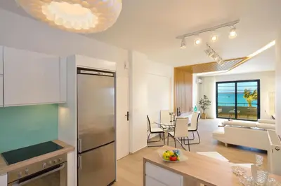 a kitchen and living room with a view of the ocean at Elia Beach in Chania Town