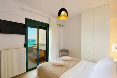 a bedroom with a bed and a view of the ocean at Elia Beach in Chania Town