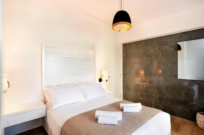 a bedroom with a bed with towels on it at Elia Beach in Chania Town