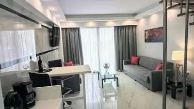 a living room with a couch and a table at Elektra Beach Hotel in Kalamaki Chanion