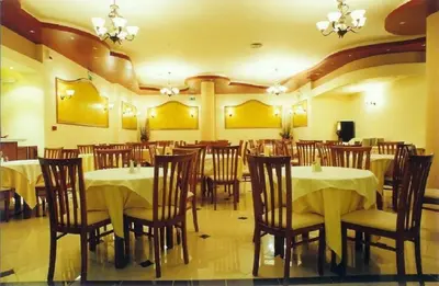 a restaurant with tables and chairs in a room at Elektra Beach Hotel in Kalamaki Chanion