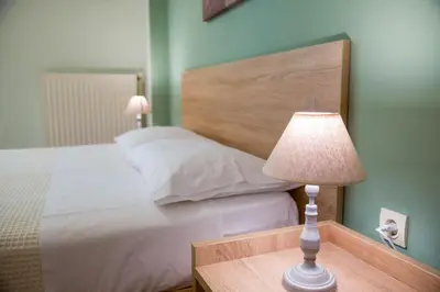 a bedroom with a bed and a table with a lamp at Downtown Studio Chania in Chania Town