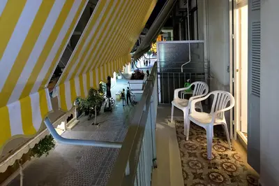 a balcony with two white chairs and a table at Emmanouil’s House in Chania Town