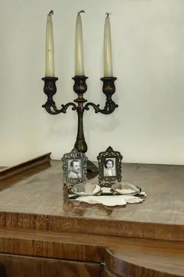 a table with two candles and two plates on it at Emmanouil’s House in Chania Town
