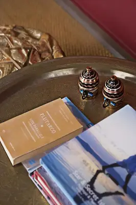 two rings on a table with a book and magazines at Alcanea Boutique Hotel in Chania Town