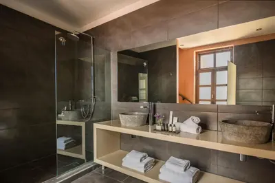 a bathroom with two sinks and a shower at Alcanea Boutique Hotel in Chania Town