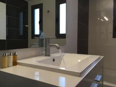 a white sink in a bathroom with a mirror at Stellar Beachhouse in Gerani Chanion