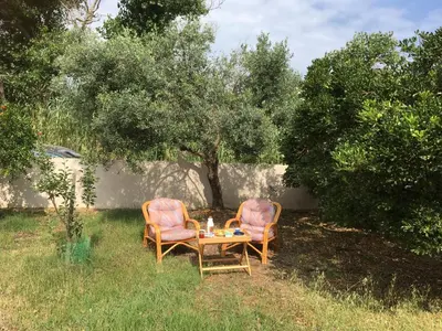 two chairs and a table in a yard at Stellar Beachhouse in Gerani Chanion