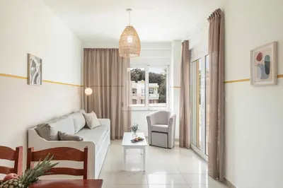 a living room with a couch and a chair at Artemis Apartments in Stalos