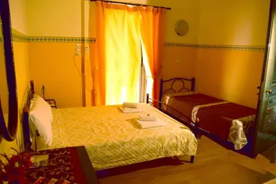 a bedroom with two beds and a window at Stoa Rooms in Chania Town
